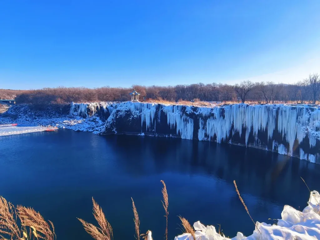 The breathtaking frozen Diaoshuilou Waterfall, a massive wall of blue ice and a premier natural destination included in our Mudanjiang travel guide.
Mudanjiang travel guide
Things to do in Mudanjiang
Mudanjiang itinerary
Jingpo Lake
China Snow Town
Siberian Tiger Park
